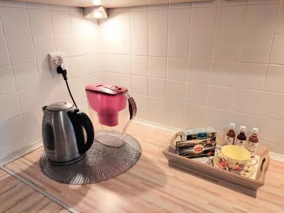 a kitchen counter with a pink coffee maker and a tray at *** Cozy and bright apartment (over 50m2) *** in Kraków