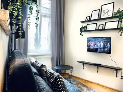 a living room with a couch and a table at Cozy Apartment in the heart of Cracow, Jewish District in Kraków