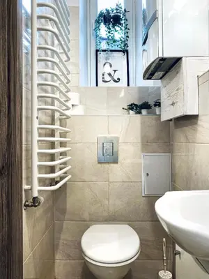 a small bathroom with a toilet and a sink at Cozy Apartment in the heart of Cracow, Jewish District in Kraków