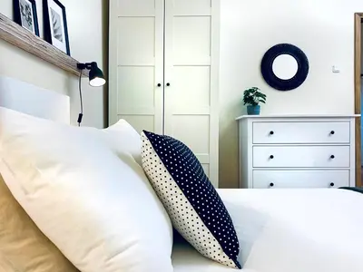 a bedroom with a bed with pillows on it at Cozy Apartment in the heart of Cracow, Jewish District in Kraków