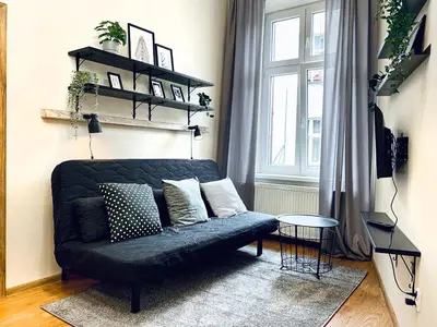 a living room with a couch and a window at Cozy Apartment in the heart of Cracow, Jewish District in Kraków