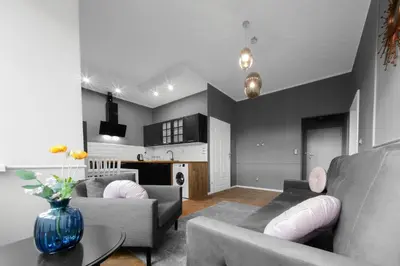 a living room with two couches and a kitchen at Aleja Krasińskiego 5 by Homeprime in Kraków