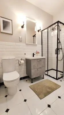 a bathroom with a toilet and a sink and a mirror at Aleja Krasińskiego 5 by Homeprime in Kraków