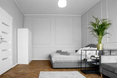 a bedroom with a bed and a potted plant at Aleja Krasińskiego 5 by Homeprime in Kraków
