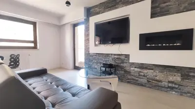 a living room with a couch and a tv on a wall at Łokietka 8B by Homeprime in Kraków