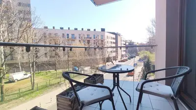 a balcony with a table and chairs and a view of a street at Łokietka 8B by Homeprime in Kraków