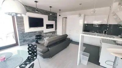 a kitchen and living room with a couch and a table at Łokietka 8B by Homeprime in Kraków