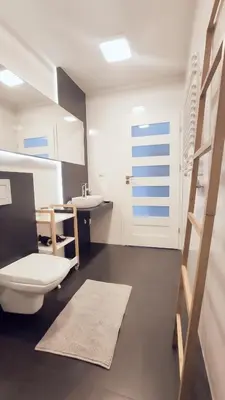 a bathroom with a toilet and a sink at Łokietka 8B by Homeprime in Kraków