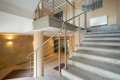 a set of stairs in a building with a stair case at Lea Apartments Kraków Krowodrza by Noclegi Renters in Kraków