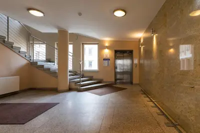 a hallway with stairs and a stair case in a building at Lea Apartments Kraków Krowodrza by Noclegi Renters in Kraków