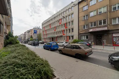 a street with cars parked on the side of the road at Lea Apartments Kraków Krowodrza by Noclegi Renters in Kraków