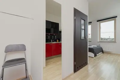a room with a door and a bedroom with a bed at Lea Apartments Kraków Krowodrza by Noclegi Renters in Kraków