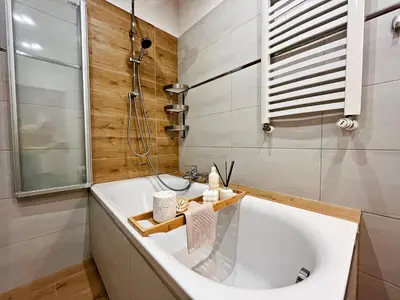 a bathroom with a tub and a shower and a sink at HARMONY Apartment - Zator Energylandia in Zator