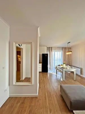 a living room with a table and a mirror at HARMONY Apartment - Zator Energylandia in Zator
