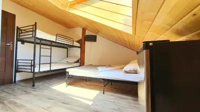a room with two bunk beds and a wooden ceiling at Noclegi u Eli Zator Energylandia in Zator
