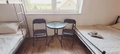 a room with three chairs and a table and a bed at Noclegi u Eli Zator Energylandia in Zator