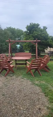 a picnic table and two benches in a park at Noclegi u Eli Zator Energylandia in Zator
