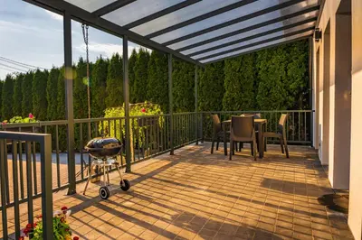 a patio with a table and chairs on a deck at Apartamenty na Jurze in Siamoszyce