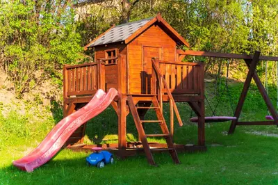 a playground with a slide and a play house at Apartamenty na Jurze in Siamoszyce