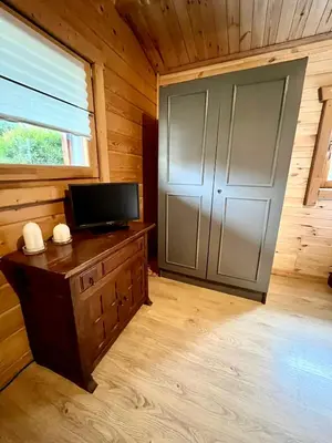 a room with a large door in a wooden cabin at Domek drewniany in Podzamcze