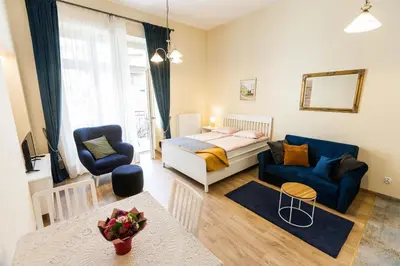 a bedroom with a bed and a living room at Vintage Sebastiana Apartment in Kraków