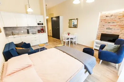 a bedroom with a bed and a living room at Vintage Sebastiana Apartment in Kraków