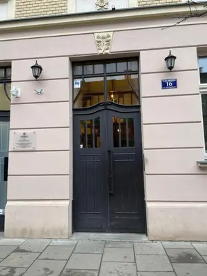 a door to a building with a sign on it at Vintage Sebastiana Apartment in Kraków