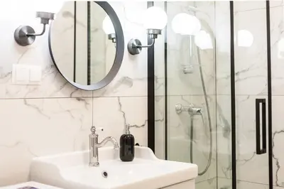 a bathroom with a sink and a shower at Vintage Sebastiana Apartment in Kraków