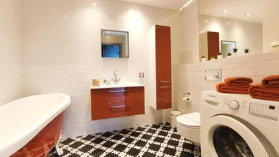 a bathroom with a toilet and a sink and a washing machine at Wrocławska 80 by Homeprime in Kraków