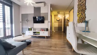 a living room with a couch and a tv at Wrocławska 80 by Homeprime in Kraków
