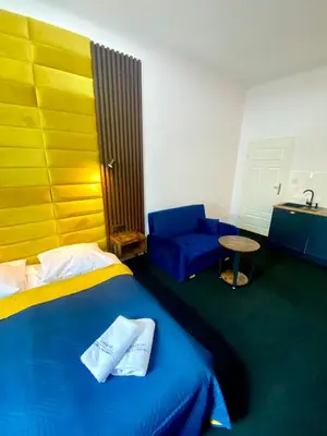 a bedroom with a blue bed and a blue couch at Old Town Gertrudy Apartment - Topolove Rooms & Apartments in Kraków