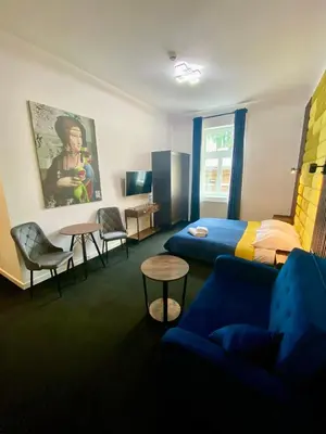 a room with a bed and a couch and a table at Old Town Gertrudy Apartment - Topolove Rooms & Apartments in Kraków
