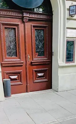 a large wooden door on the side of a building at Old Town Gertrudy Apartment - Topolove Rooms & Apartments in Kraków