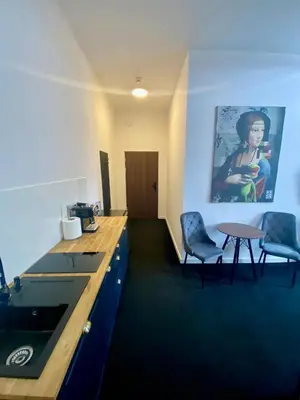 a room with a desk and two chairs and a table at Old Town Gertrudy Apartment - Topolove Rooms & Apartments in Kraków