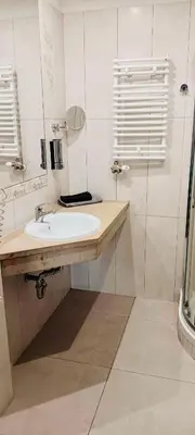 a white bathroom with a sink and a shower at Old Town Gertrudy Apartment - Topolove Rooms & Apartments in Kraków