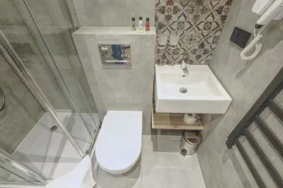 a small bathroom with a toilet and a sink at Skansen Forest in Liszki