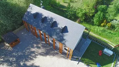 an overhead view of a house with a blue roof at Skansen Forest in Liszki