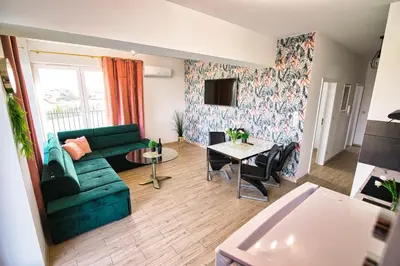 a living room with a table and chairs and a couch at Apartament The Palm 35 by Housine in Zator