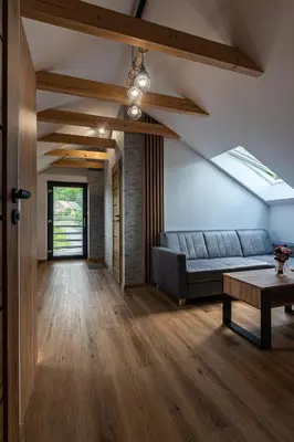 a living room with a couch and a table at Bianco Apartamenty Laskowa - Zator in Zator