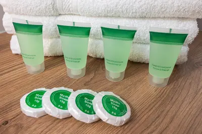 a group of four bottles of face cream on the floor at Bianco Apartamenty Laskowa - Zator in Zator