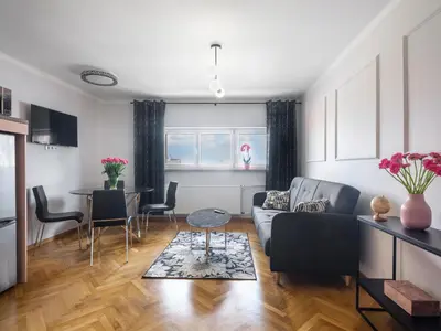 a living room with a couch and a table at CracWoW City Center Apartment in Kraków