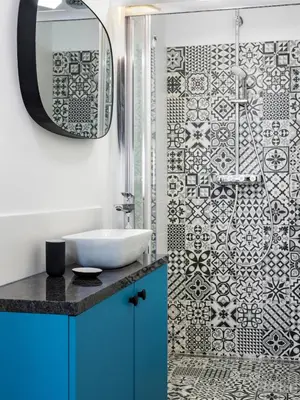 a bathroom with a sink and a shower with a mirror at CracWoW City Center Apartment in Kraków
