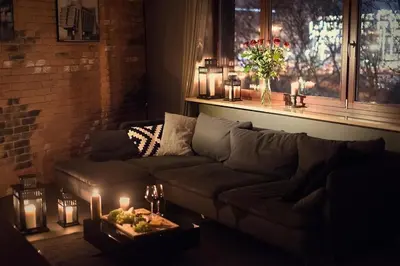 a living room with a couch and candles on a table at Premium Apartment for Old Town & Jewish Quarter plus Pool in Kraków