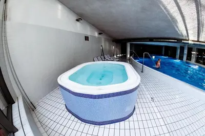 a large bath tub in a bathroom with a swimming pool at Premium Apartment for Old Town & Jewish Quarter plus Pool in Kraków