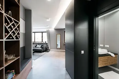 a bathroom with a black door and a living room at Premium Apartment for Old Town & Jewish Quarter plus Pool in Kraków
