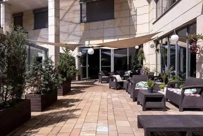 a patio with couches and tables in front of a building at Premium Apartment for Old Town & Jewish Quarter plus Pool in Kraków