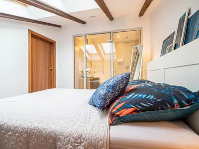 a bedroom with a bed with two pillows on it at Apartament Bocheńska in Kraków