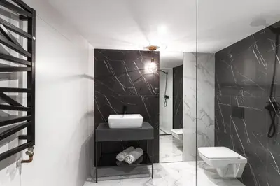 a bathroom with a sink and a toilet at Aparts Jablonowskich in Kraków