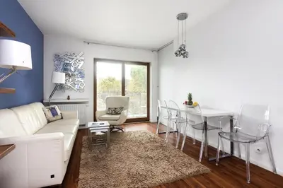 a living room with a white couch and a table at Pawia Apartments Modern 2 in Kraków
