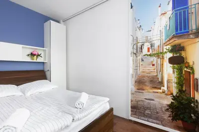 a bedroom with a bed and a view of a street at Pawia Apartments Modern 2 in Kraków